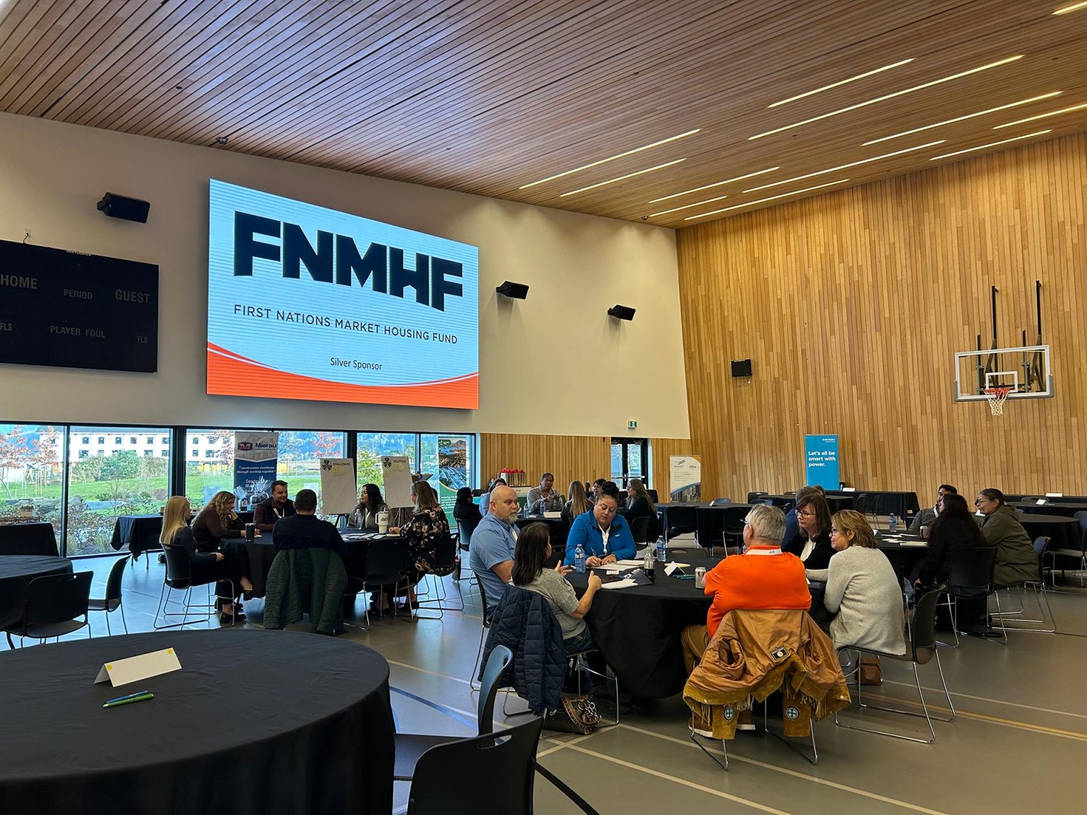 Conference with attendees around tables.